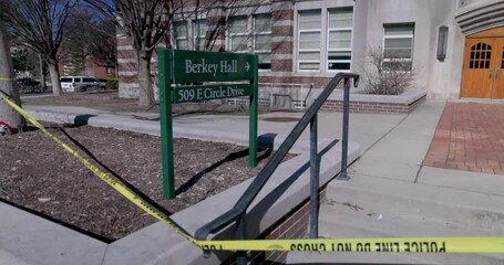 Berkey Hall on the campus of Michigan State University with close up of sign and police tape. The site of a mass shooting in February of 2023.