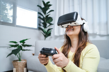 Young Asian woman gamer wearing virtual reality touching air during the VR experience  Future home technology player hobby playful enjoyment concept.