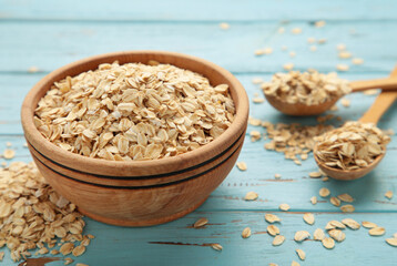 Oatmeal in bowl on blue background. Healthy eating concept.