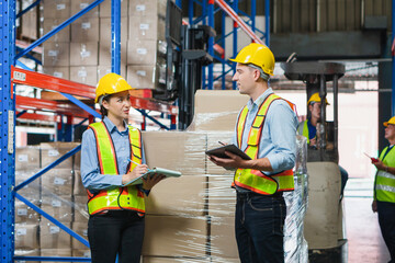 Workers team working in warehouse, Manager and supervisor taking inventory in warehouse, Female foreperson making plans with warehousemen