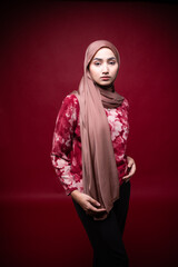 Portrait of hijab girl smiling. Pretty muslim girl. Beautiful asian muslimah woman model posing on background studio.