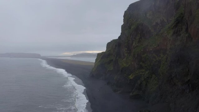 Aerial: Reynishjara black sand beach in Iceland during a rainy day