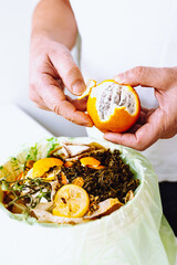 Sorting and composting food waste at home in kitchen