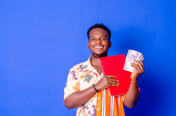 Portrait of excited young modern businessman standing holding laptop