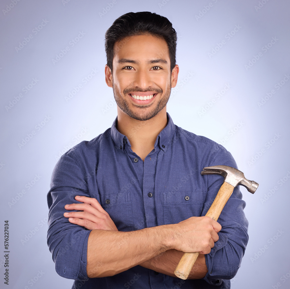 Poster Man, studio and portrait with tools or hammer for handyman, maintenance or repair work with smile. Happy asian model person on purple background arms crossed for engineer, mechanic or technician job