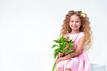 Obraz na płótnie Canvas little beautiful cute curls blonde girl with bouquet. Child with astromeria flowers in hands. spring holiday kid concept, international women's day, March 8, mother's day. banner