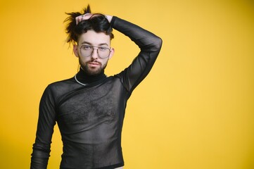 Young, handsome gay man on a colored background in the studio. LGBT concept.