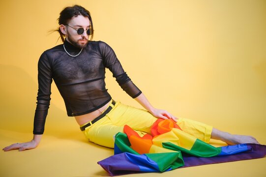 Youth Transgender LGBT With Rainbow Flag On Shoulder Isolated Color Background. Gender Expression Pride And Equality Concept.