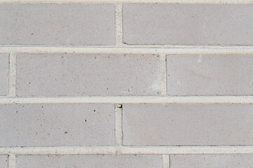 Light gray brick wall. Grunge brick wall texture background. Close-up picture of brick wall. 