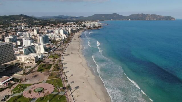 Aerial footage videoof  Cala Millor beach in the island of Majorca. Summer, beach, holiday, resort and vacation scene.
