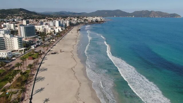 Aerial footage videoof  Cala Millor beach in the island of Majorca. Summer, beach, holiday, resort and vacation scene.