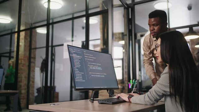 Group of Programmers Working On Big Data Processing In Office, Black Man And Asian Woman Discussing
