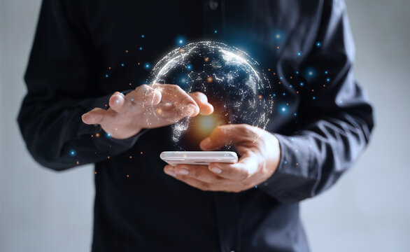 Businessman using smartphone with globe icon, connection with business, marketing, stock and virtual blockchain technology on mobile network technology.