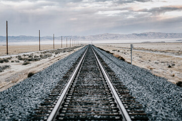 Railroad tracks crossing barren desert, Salt Lake City, Utah, USA