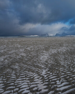 Patters of snow on sand at Ytresand beach in winter, Moskenes&Atilde;&cedil;y, Lofoten Islands, Norway