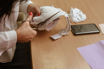 Closeup of woman fashion designer working on clothes in tailoring atelier