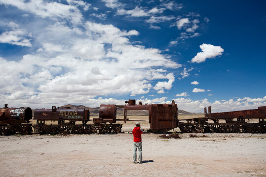 A man takes a photo of a deserted train in the Atacama Desert. The Salar de Uyuni is the world's largest salt flat and home to one of the largest deposits of lithium in the world. 