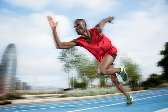 Male athlete sprinting on all-weather running track, Barcelona, Spain