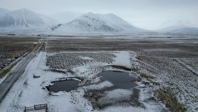 Iceland Landscape with One Road leading to Snowy Mountains, Aerial