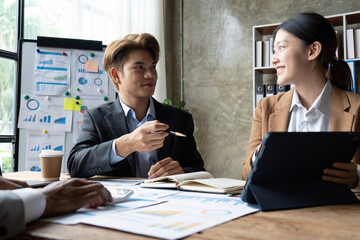 Business people meeting using laptop computer, calculator, stock market chart paper for analysis planning to improve quality next month. Conference discussion corporate concept