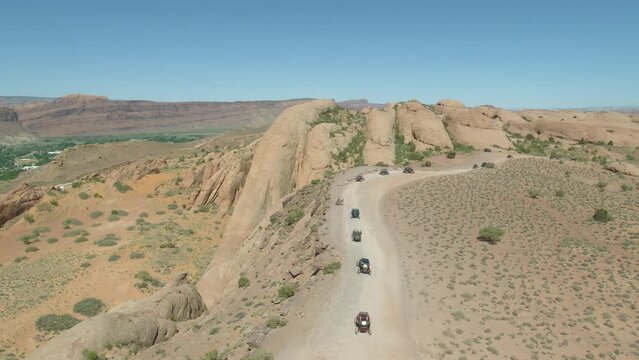 Aerial Of Line Of UTVs On Red Dirt Trail In Moab Utah On Red Slick Rock