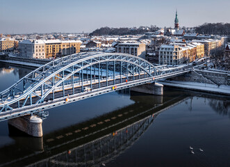 Aerial view of old, steel Pilsudski Bridge which connect Podgorze and Krakow, Poland during winter.