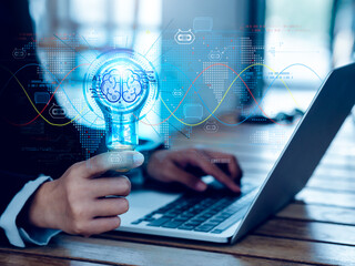 Artificial intelligence chat bot technology concept. Glow digital light bulb graphics with AI brain system inside, hold by business person. Chatbot intelligent digital customer service application.