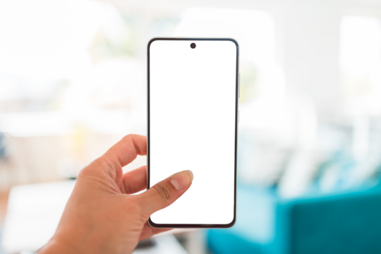 hand holding smartphone with copy space in front of stylish living room home interior background, shot at shallow depth of field