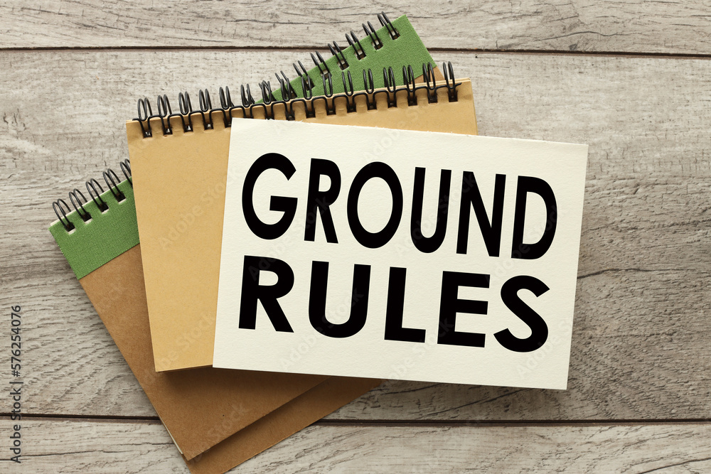 Poster ground rule. three notebooks on the table. text on the page.