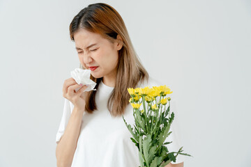 Pollen Allergies, young woman sneezing in a handkerchief or blowing in a wipe, allergic to wild...