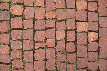 Close up of the detail of colorful cobblestones in an old street. An old road paved with granite...