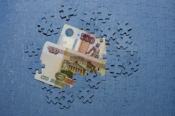 ruble bills hidden under puzzle pieces, frozen foreign exchange reserves, seized assets of...