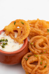 Indian Kesari Jalebi Also Called Jilapi, Jilebi, Jilipi, Zulbia, Jerry, Zalebi, Mushabak Topped With Creamy Lachhedar Malai Rabri Also Called Khurchan Rabdi, Lachha Rabidi Consumed On Diwali And Holi