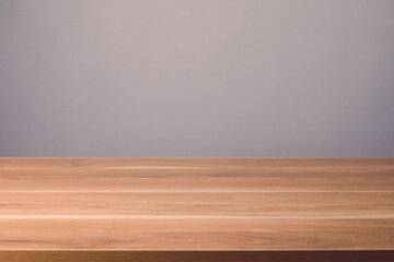 Wooden table top on grey wall background. For Mockup or product advertising display