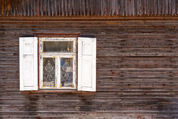 Old wooden house,window with open white shutters