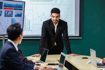 Millennial Asian Indian professional successful bearded male businessman presenter speaker in...