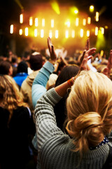 The crowd goes wild. Rearview shot of a crowd of young people at an outdoor music festival.