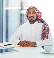 Here to work hard. Success depends on it. Portrait of a confident young muslim businessman working at his desk in a modern office.