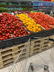 Shopper cart in vegetable department supermarket
