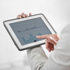 Working with the statistics. Cropped image of a businessman holding a digital tablet showing business data.
