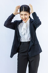 Portrait isolated cutout studio shot Millennial Asian professional successful female businesswoman in formal business suit holding hands on head having headache shouting on white background