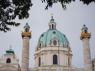 Fototapeta na wymiar Catholic church located in the southern part of Karlsplatz, Vienna. One of the symbols of the city. The Karlskirche is a prime example of the original Austrian Baroque style. cathedral details