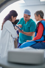 Obraz premium So this is what we found. Shot of a mature woman talking with doctors before and MRI scan.