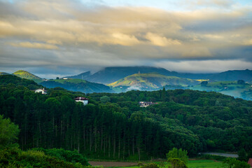 Fototapeta na wymiar landscape with forest and mountains, mountain peaks in the clouds. Basque Country, Spain
