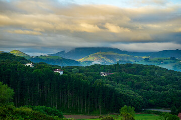Fototapeta premium landscape with forest and mountains, mountain peaks in the clouds. Basque Country, Spain
