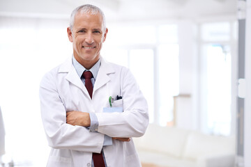 Your health is my number one priority. Portrait of a mature doctor standing with his arms crossed.