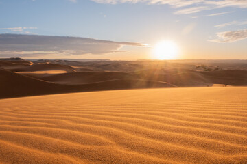 Fototapeta na wymiar Gorgeous and unique sunset seen from the orange sand dunes of the sahara desert 