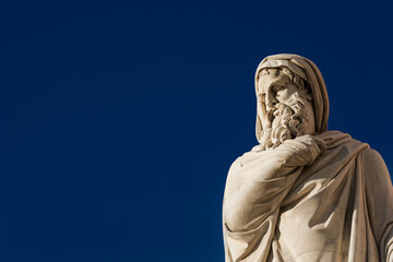 Old and wise man statue. A neoclassical marble statue erected in 1824  in Rome People's Square (with blue sky and copy space)