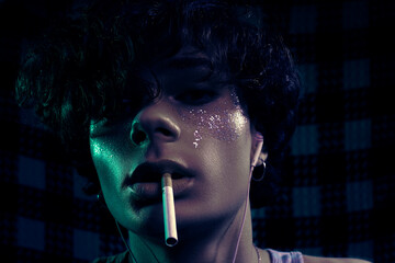 Stoned guy with glitter tears, cigarette in mouth and earphones