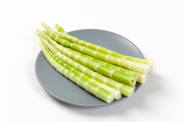 Peeled green bamboo shoots isolated on white background.